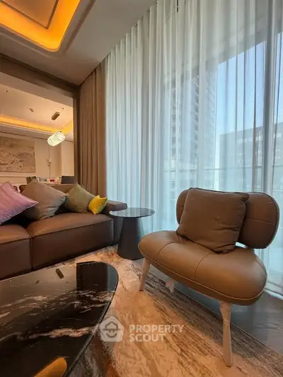 Luxurious modern living room with elegant furniture and floor-to-ceiling windows.