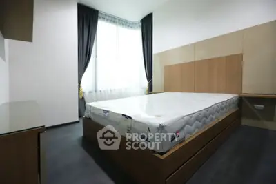 Spacious bedroom with modern design and large window for natural light