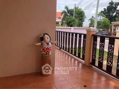 Charming balcony with decorative railing and playful garden statue, perfect for relaxation and outdoor enjoyment.
