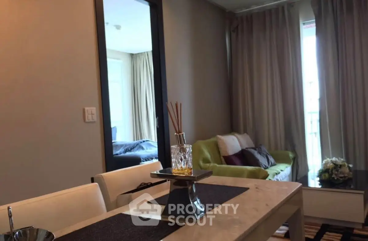 Modern living room with elegant dining area and cozy seating.