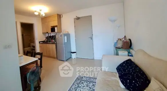 Cozy living room with open kitchen layout and modern furnishings