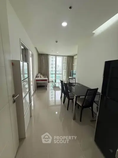 Spacious modern dining area with sleek furniture and large windows offering natural light.