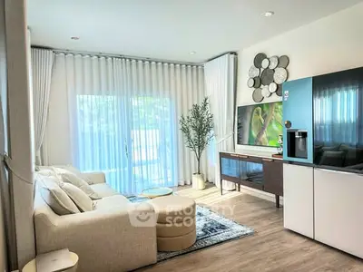Modern living room with stylish decor, large windows, and cozy seating area.
