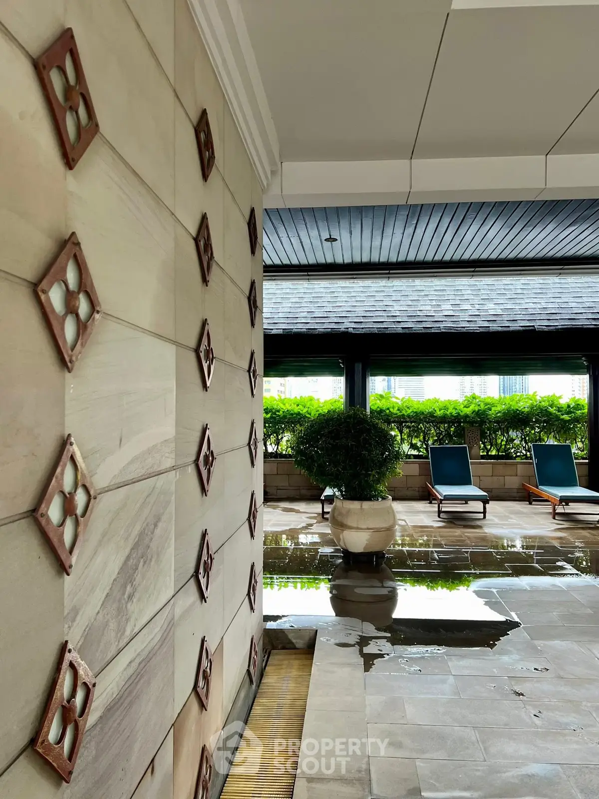 Luxurious poolside area with elegant design and lush greenery, perfect for relaxation and leisure.