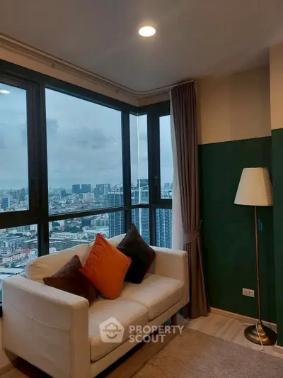 Stylish living room with panoramic city view and cozy seating area.