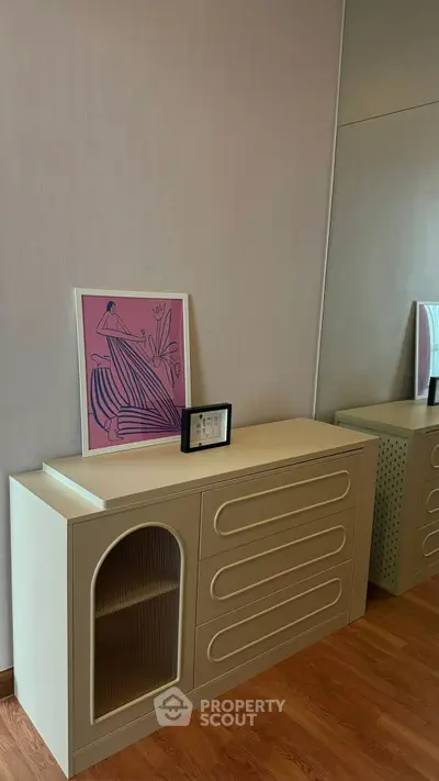 Stylish modern interior with elegant sideboard and artistic decor in a cozy living space.