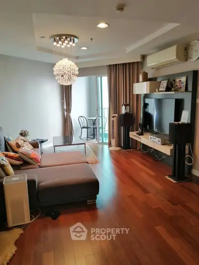 Spacious living room with modern decor and balcony access
