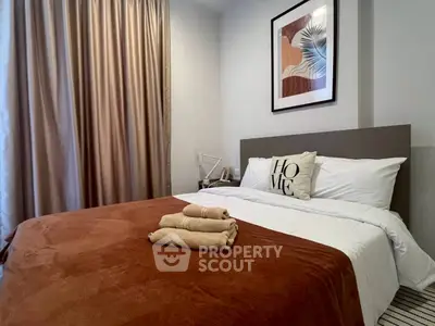 Cozy bedroom with modern decor and warm lighting, perfect for relaxation.