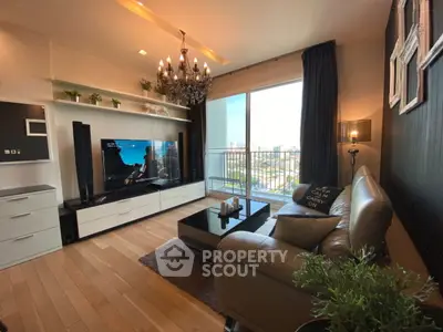 Stylish modern living room with chandelier and city view balcony.