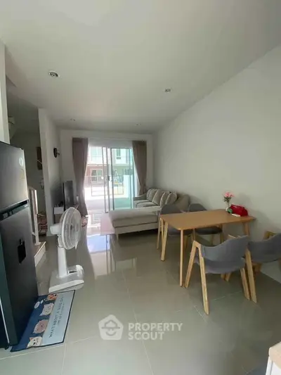 Modern living room with cozy sofa and dining area in bright apartment