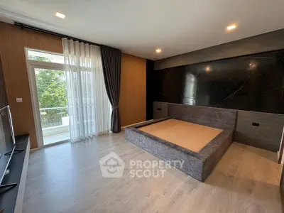 Spacious modern bedroom with large window and elegant decor