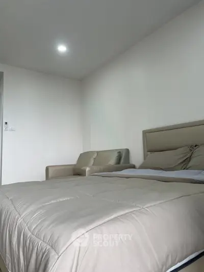 Modern bedroom with cozy bed and stylish decor in a contemporary apartment.