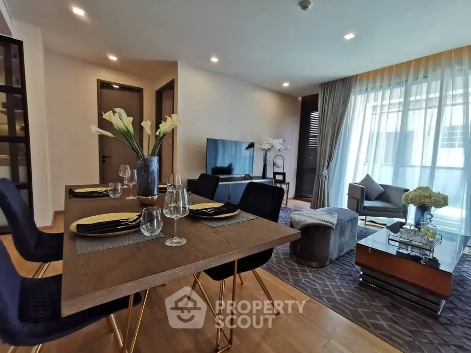 Modern living room with elegant dining area and stylish decor in a luxurious apartment.