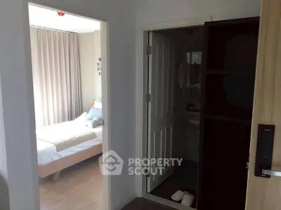 Cozy bedroom with modern decor and adjacent bathroom in a stylish apartment.