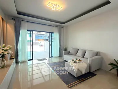 Modern living room with sleek design and large windows offering ample natural light.