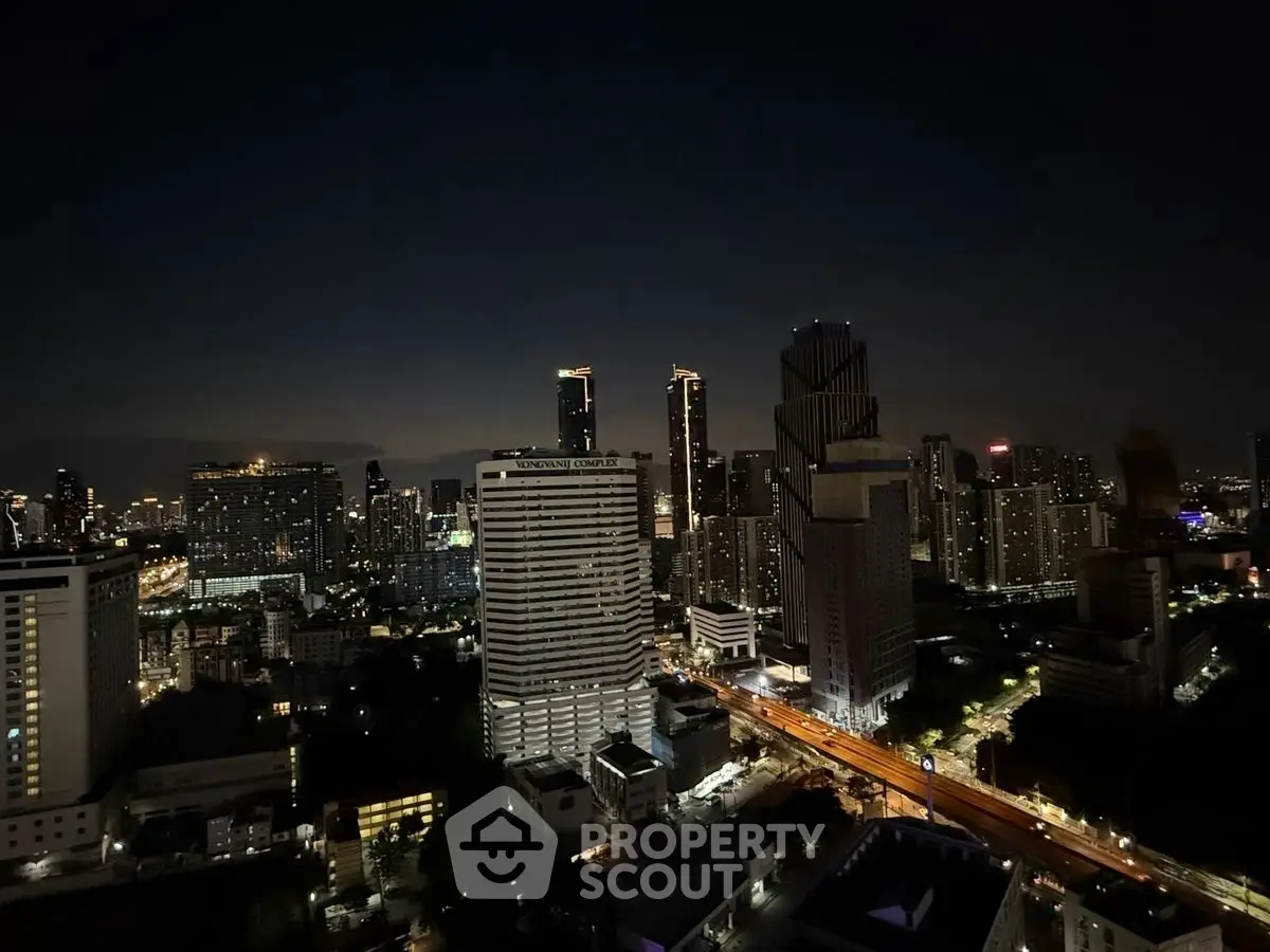 Stunning nighttime cityscape view showcasing a vibrant urban skyline with illuminated skyscrapers.