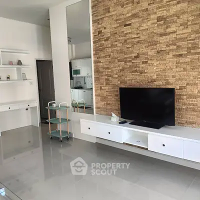 Modern living room with stone accent wall and sleek TV setup
