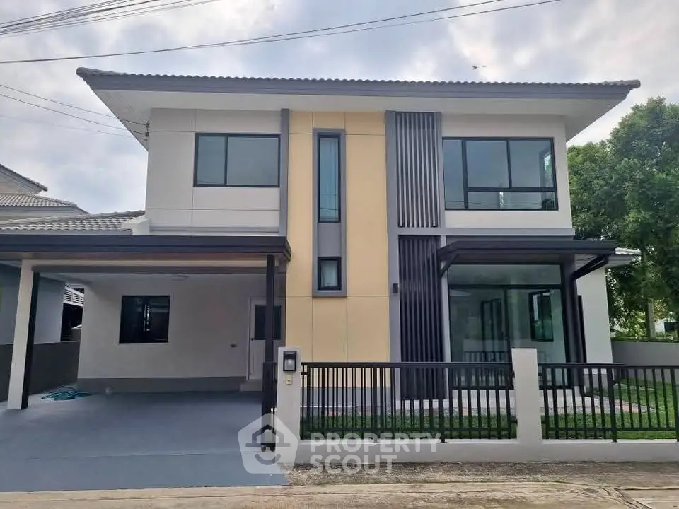 Modern two-story house with sleek design and large windows, perfect for contemporary living.