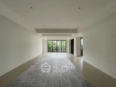 Spacious modern living room with large windows and garden view, perfect for natural light lovers.