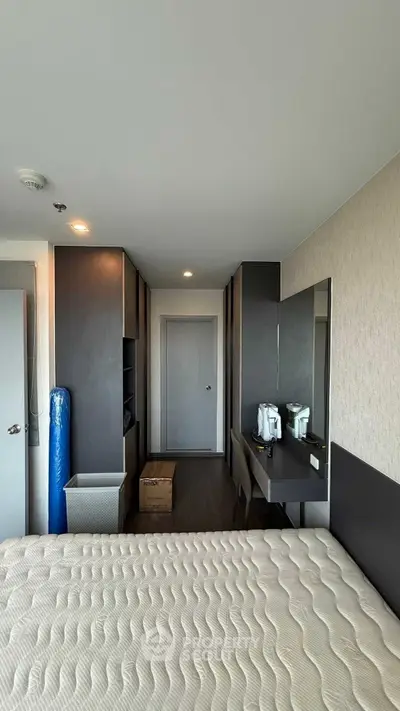 Modern bedroom with sleek design and ample storage in a high-rise apartment.