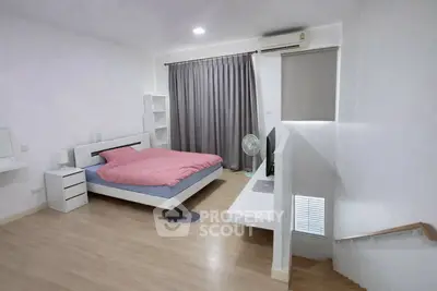 Modern minimalist bedroom with wooden flooring and stylish decor