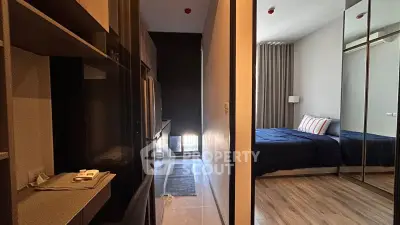 Modern apartment interior with cozy bedroom and sleek kitchen area.