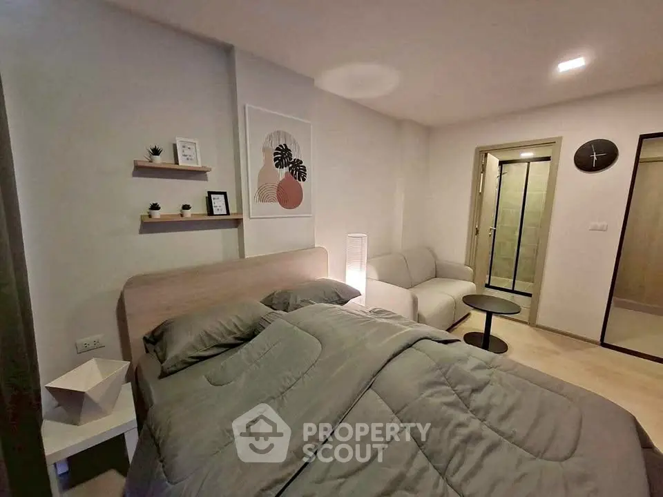 Cozy bedroom with modern decor and ensuite bathroom in stylish apartment.