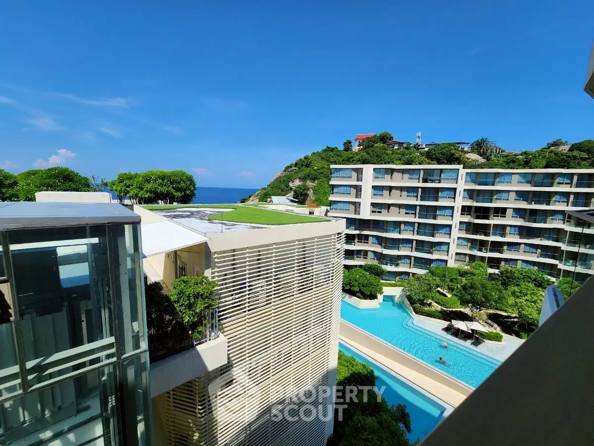 Luxurious seaside apartment complex with stunning pool and ocean view