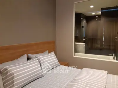 Modern bedroom with glass window view into luxurious bathroom