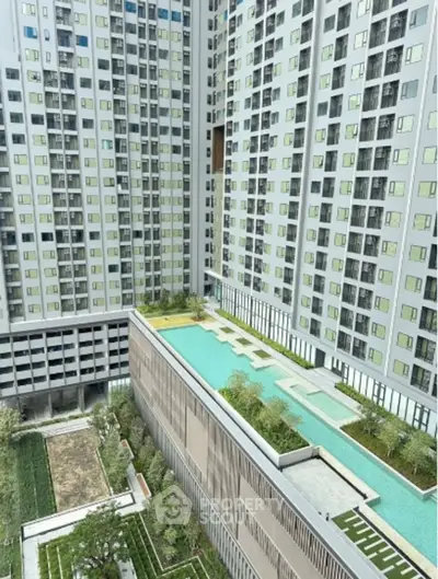 Modern high-rise building with rooftop pool and lush garden views.