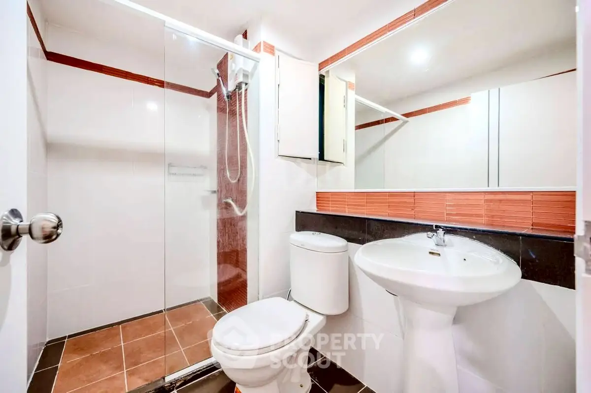 Modern bathroom with glass shower and sleek fixtures