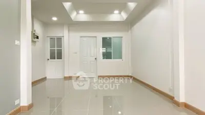 Spacious modern living room with glossy tiled floors and recessed lighting