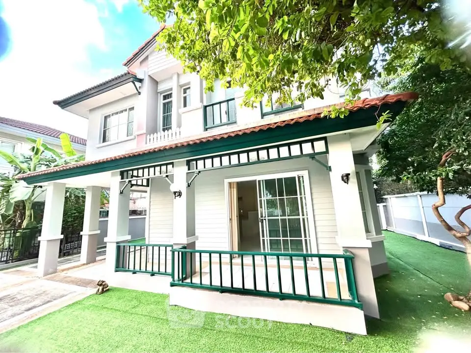 Charming two-story house with lush garden and spacious balcony, perfect for family living in a serene neighborhood.