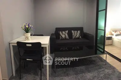 Cozy living room with modern sofa and dining table in compact apartment