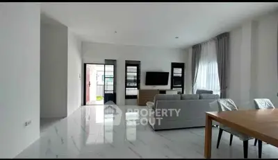 Spacious modern living room with sleek design and abundant natural light