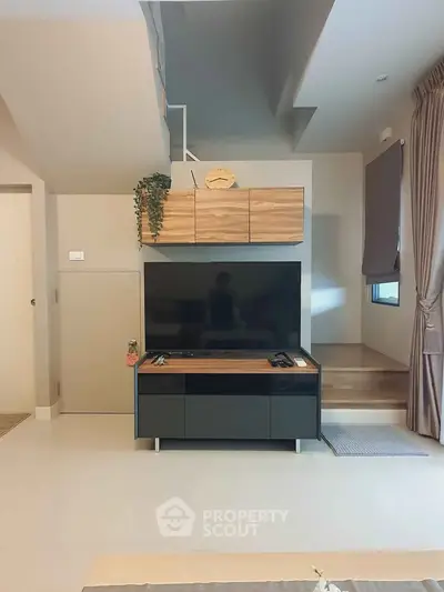 Modern living room with sleek TV stand and wooden accents