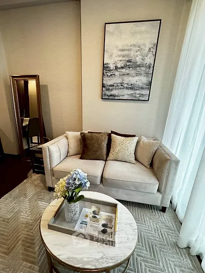 Elegant living room with plush sofa, chic decor, and stylish coffee table.