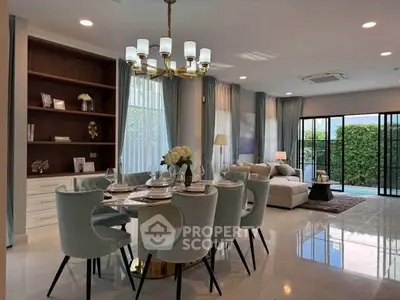 Luxurious open-plan living and dining area with elegant decor and pool view.