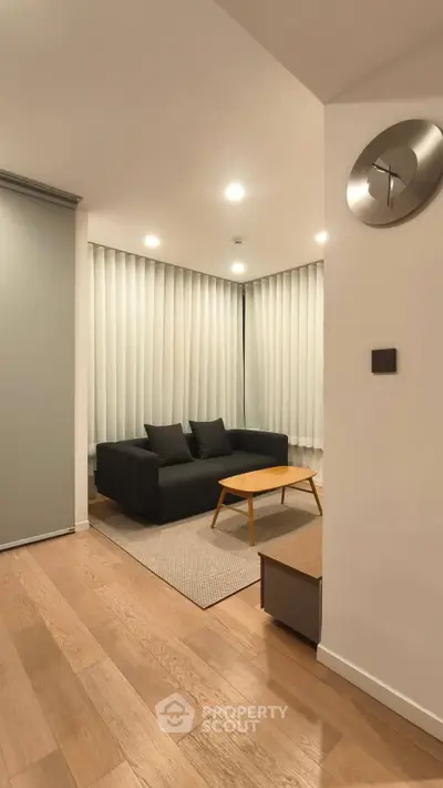 Modern living room with sleek black sofa and minimalist decor