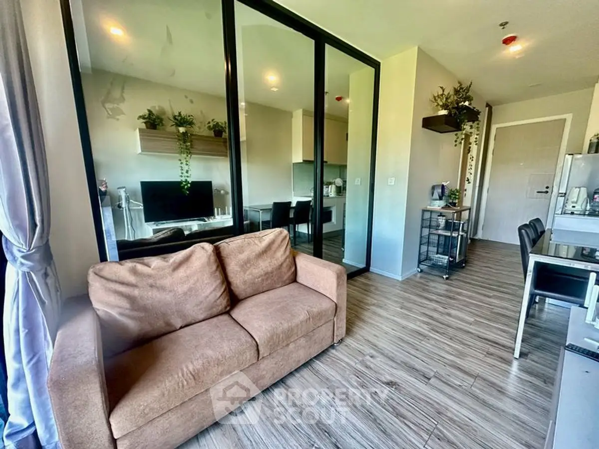 Modern living room with glass partition and cozy brown sofa