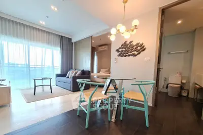 Modern open-plan living room with stylish furniture and large windows in a contemporary apartment.