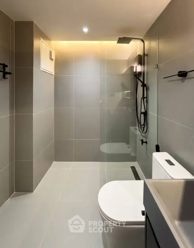 Modern minimalist bathroom with sleek fixtures and glass shower enclosure