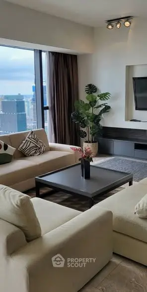 Luxurious living room with city view, modern furniture, and elegant decor.