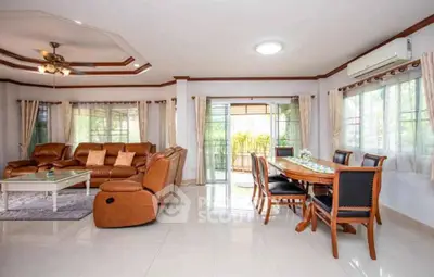 Spacious living room with elegant dining area and large windows for natural light.