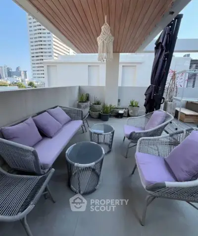 Stylish balcony with modern furniture and city view, perfect for relaxation and entertaining.