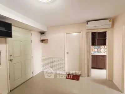 Spacious entryway with modern kitchen and air conditioning unit in a stylish apartment.