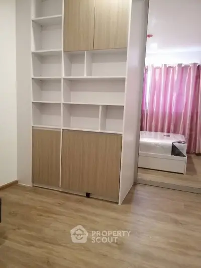 Modern bedroom with built-in storage and mirrored closet doors