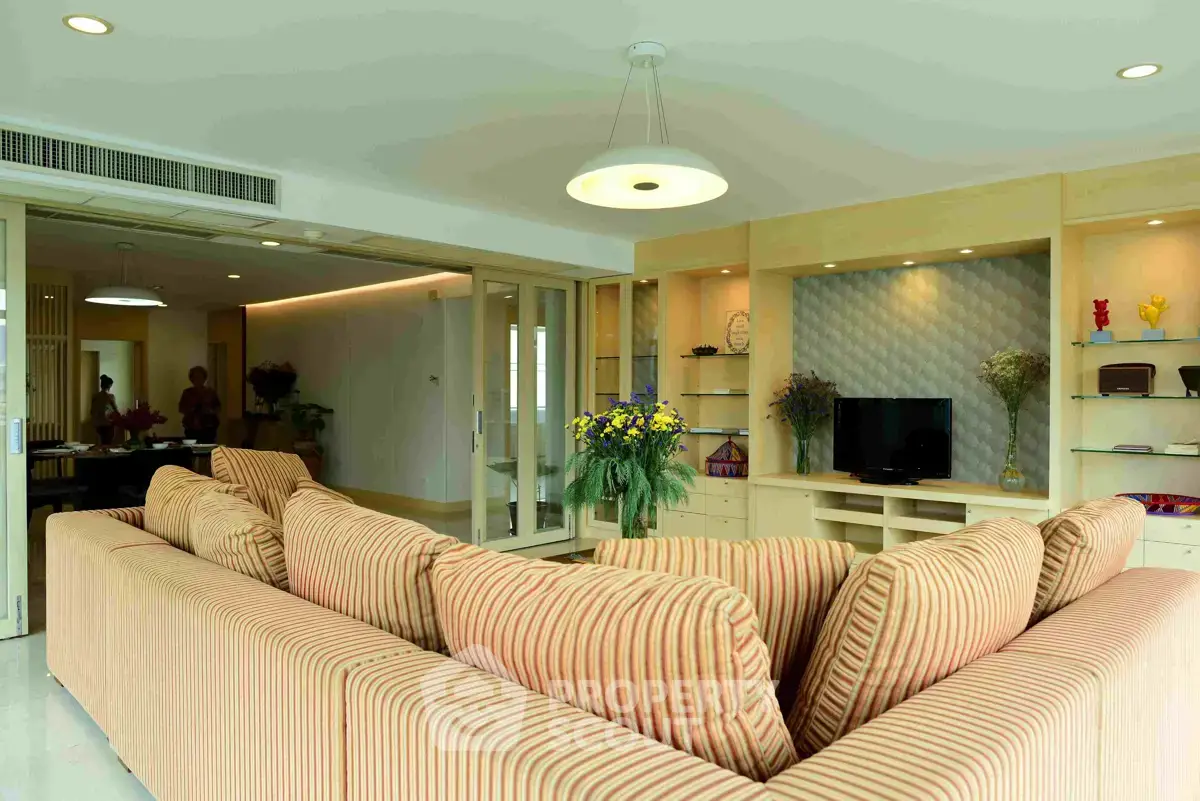 Spacious living room with modern decor and comfortable seating in a luxury apartment.
