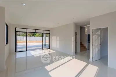 Spacious modern living room with large windows and glossy floors
