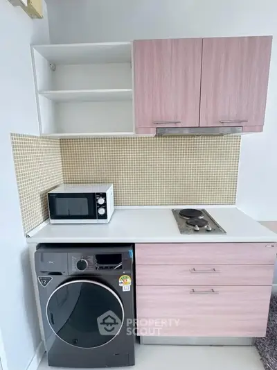 Compact kitchen with modern appliances and stylish cabinetry